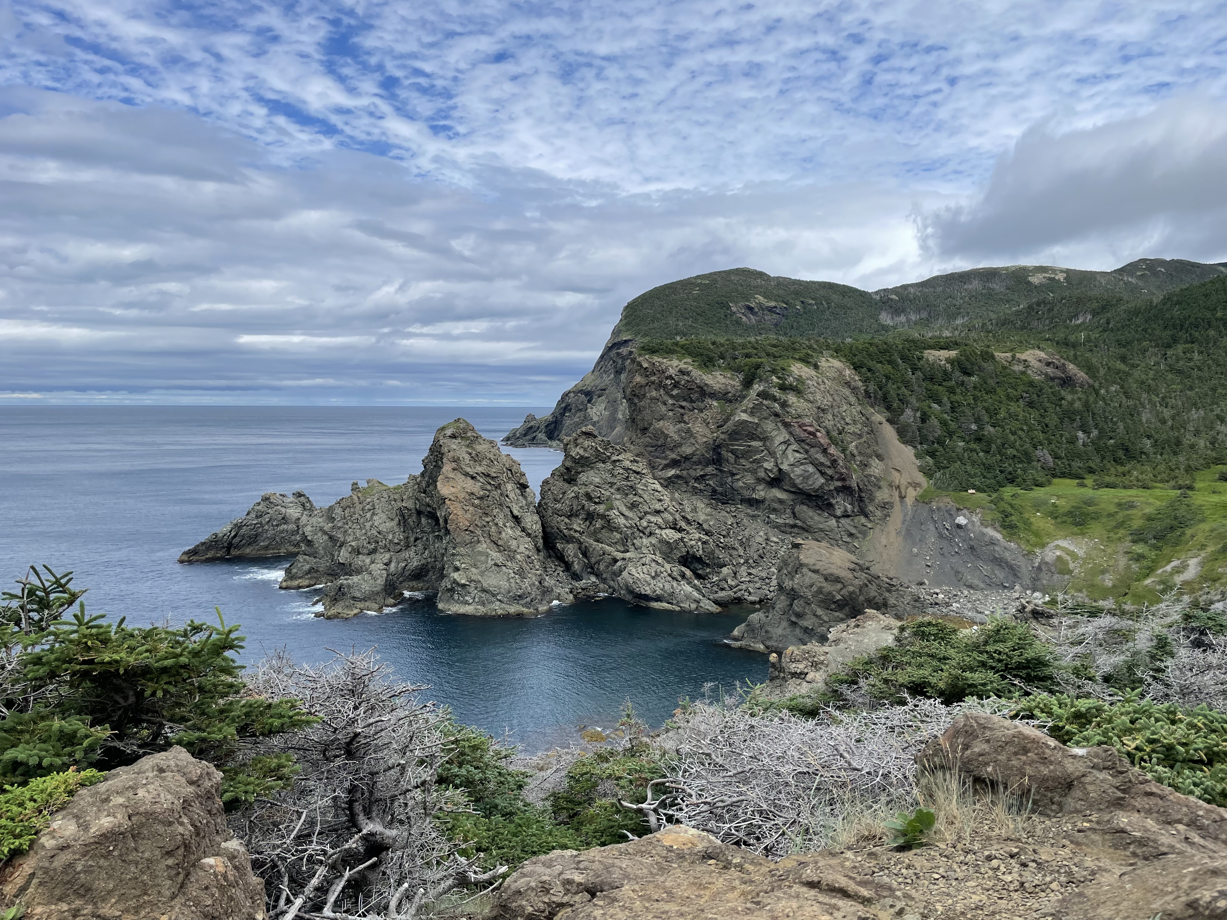 a colourful panoramic view of cliff, sky and sea