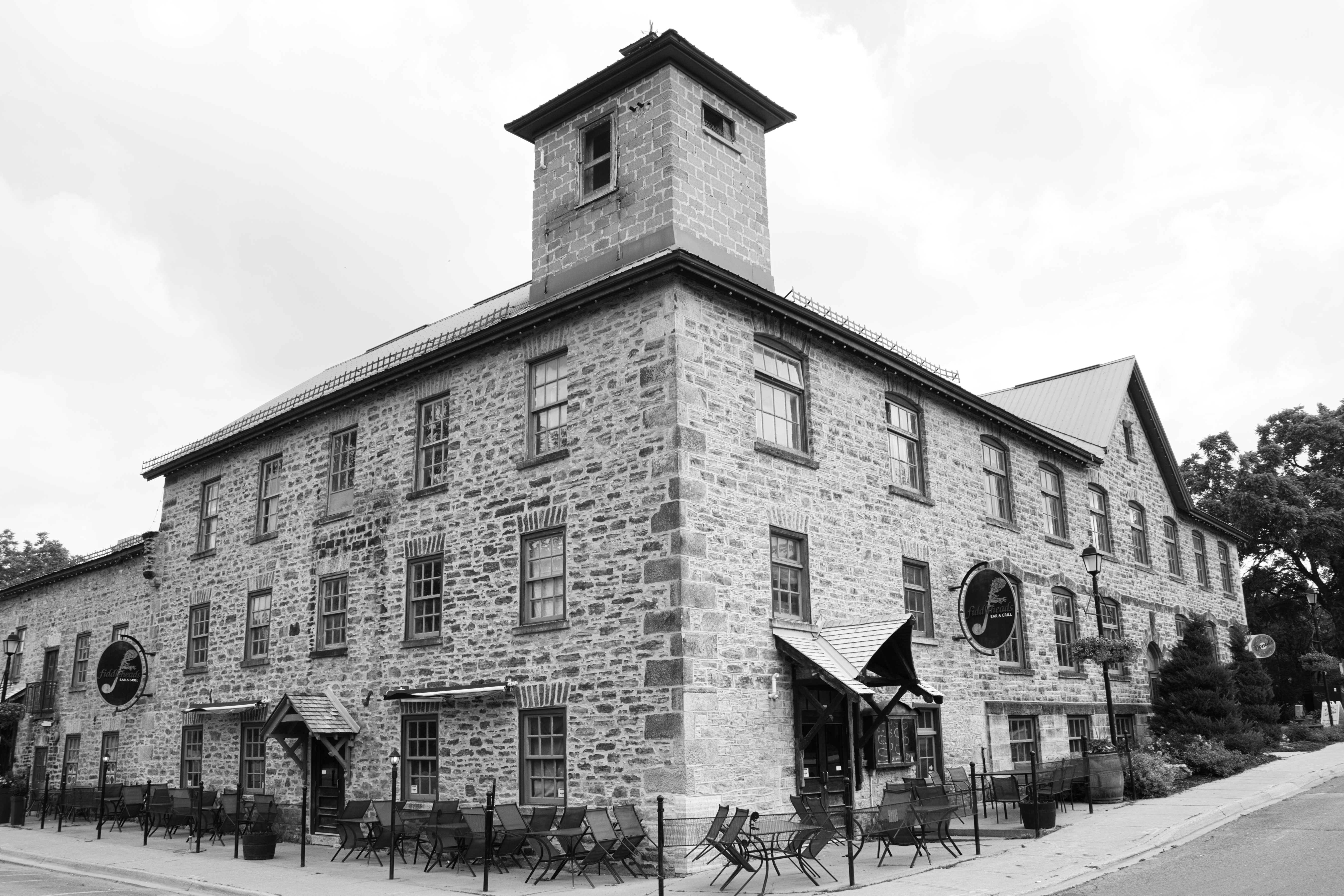 a black and white view of Codes Mill showing the two sides of the building from the corner